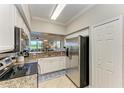 Modern kitchen with stainless steel appliances, granite countertops, and ample cabinet space at 7019 River Hammock Dr # 104, Bradenton, FL 34212