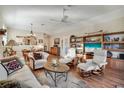 Spacious living room with hardwood floors, custom built-ins, and bright, natural light at 7340 Golf Pointe Cir, Sarasota, FL 34243
