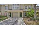 Charming townhome showcases a well-kept front yard, garage, and covered entrance at 7632 Plantation Cir, Bradenton, FL 34201