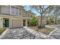 Inviting townhome exterior features well-maintained landscaping, and a garage with driveway at 7632 Plantation Cir, Bradenton, FL 34201