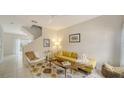 Bright living room with stylish furniture, patterned rug, and staircase at 7632 Plantation Cir, Bradenton, FL 34201