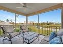 Inviting screened lanai offers comfortable seating and serene views of the golf course and water at 1620 Fairway Trce # B, Palmetto, FL 34221