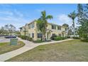 Charming townhouse exterior featuring well-maintained lawns and lush landscaping, creating a welcoming curb appeal at 208 Cape Harbour Loop # 108, Bradenton, FL 34212