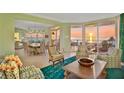Bright and airy living room with dining area features ocean views and stylish furnishings at 2141 Gulf Of Mexico Dr Unit # 4, Longboat Key, FL 34228