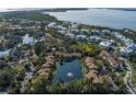 Beautiful aerial view of community featuring pond, lush landscaping, and views of the bay at 3810 75Th W St # 123, Bradenton, FL 34209