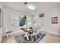Bright dining room with a modern table, stylish decor, shiplap walls and lovely natural light at 432 W Gate Dr, Venice, FL 34285