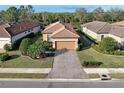 An aerial view showcases the property's meticulously maintained lawn, landscaping, and paved driveway at 5020 Savona Run, Bradenton, FL 34211