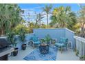 Relaxing outdoor patio area with stylish furniture and lush plants at 5250 Calle De Rio, Sarasota, FL 34242