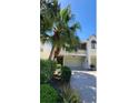 Charming two-story townhome surrounded by lush tropical landscaping at 625 Duchess Blvd, Dunedin, FL 34698