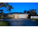 Charming single-story home boasts a well-manicured lawn, two-car garage, and lush tropical landscaping at 721 Cadiz Rd, Venice, FL 34285