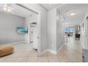 Bright hallway featuring tile flooring, neutral paint, and an open doorway leading to other rooms at 147 Tampa E Ave # 702, Venice, FL 34285