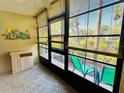 Enclosed lanai with tiled floor, window blinds and view of greenery at 1515 Forrest Nelson Blvd # P107, Port Charlotte, FL 33952