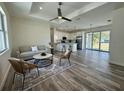 Bright open-concept living room and kitchen with ceiling fan and sliding glass doors to the backyard at 18290 Grace Ave, Port Charlotte, FL 33948