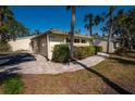 Well-maintained home exterior with lush landscaping, charming walkway and a two car garage at 231 Hourglass Way # V5, Sarasota, FL 34242
