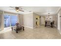 Open-concept living room and dining area with tile floors, a ceiling fan, and a sliding glass door to the patio at 2416 Webber St, Sarasota, FL 34239