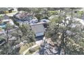 An aerial view of a home showing the mature trees, the backyard, and the surrounding neighborhood at 2900 Woodpine Ct, Sarasota, FL 34231