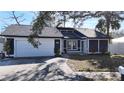 Lovely single-level home with a two-car garage and a neatly maintained front yard at 2900 Woodpine Ct, Sarasota, FL 34231