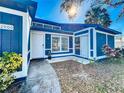 Charming home exterior featuring blue accents, white trim, and a well-maintained front yard at 2900 Woodpine Ct, Sarasota, FL 34231