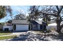 Attractive one-story home with a two-car garage, mailbox, and tidy landscaping at 2900 Woodpine Ct, Sarasota, FL 34231