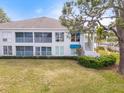 Back exterior view with screened in porch and luscious green grass at 312 108Th W St, Bradenton, FL 34209