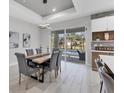Bright dining area features pool views, modern light fixture, and seating for six at 4529 Crowell Ln, North Port, FL 34288