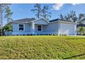 A charming single-story home with a well-manicured lawn and fresh landscaping, offering great curb appeal at 4529 Crowell Ln, North Port, FL 34288
