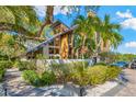 Beautiful home exterior featuring modern design, lush landscaping and paved driveway at 5236 Siesta Cove Dr, Sarasota, FL 34242