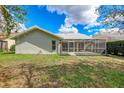 View of backyard from a home with a screened lanai, on a sunny day at 6409 Stone River Rd, Bradenton, FL 34203