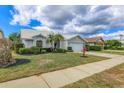 Attractive single-story home with manicured lawn, front garden, and a bright sky at 6409 Stone River Rd, Bradenton, FL 34203
