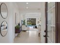 Inviting foyer leading to an open-concept living area with views of the pool and outdoor space at 11728 Strandhill Ct, Lakewood Ranch, FL 34202