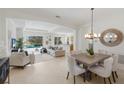 Open-concept living space featuring a dining area and a living room with seamless access to the outdoor pool area at 11728 Strandhill Ct, Lakewood Ranch, FL 34202