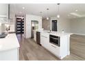 Modern kitchen featuring an island, stainless steel appliances, and bright white cabinets at 1471 Palmwood Dr, Sarasota, FL 34232
