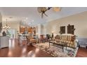 Spacious living room with hardwood floors and a view into the gourmet kitchen at 3445 Highlands Bridge Rd, Sarasota, FL 34235