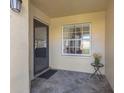 Welcoming front porch with tiled floor, security screen door and a decorative side table at 3522 57Th Avenue W Cir, Bradenton, FL 34210