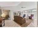 Cozy living room with neutral colors, a ceiling fan, and access to the screened-in porch at 3522 57Th Avenue W Cir, Bradenton, FL 34210