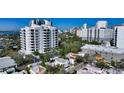 Stunning aerial view of a neighborhood featuring a high-rise condo with bay views at 422 Burns Ct, Sarasota, FL 34236