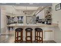 Open kitchen with a breakfast bar, white cabinetry, and a view into the adjacent dining area at 5008 30Th Street E Ct, Bradenton, FL 34203