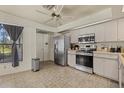 Efficient kitchen with stainless steel appliances, light neutral cabinets, and durable tile flooring at 5008 30Th Street E Ct, Bradenton, FL 34203