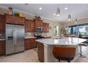 Kitchen featuring stainless steel appliances, granite countertops, wood cabinets, and breakfast bar at 5040 Lake Overlook Ave, Bradenton, FL 34208