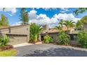 A contemporary home exterior with a private driveway and attached garage at 5135 Riverwood Ave, Sarasota, FL 34231