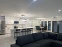 Open-concept kitchen features stainless steel appliances, a large island, and adjacent dining area at 5174 Conner Ter, Port Charlotte, FL 33981