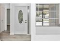 Bright entryway featuring new flooring, a decorative door, and a window with blinds at 6124 Green View Dr # 139, Sarasota, FL 34231