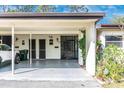 Image of the home's covered driveway with storage and the front entrance at 6124 Green View Dr # 139, Sarasota, FL 34231