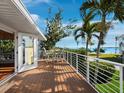 Inviting balcony features seating and stunning waterfront views from this lovely home at 691 Linley St, Longboat Key, FL 34228