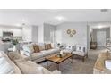 Bright, open living room with modern furnishings, neutral tones, and easy access to the kitchen at 128 Sequoyah Dr, Port Charlotte, FL 33954