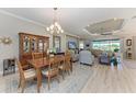 Open-concept living room and dining room features lovely decor and a view of the golf course at 15209 Montello Way, Bradenton, FL 34211