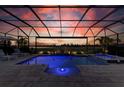 Relaxing screened-in pool area with a spa overlooking a scenic golf course view at 15209 Montello Way, Bradenton, FL 34211