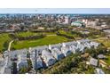 Stunning aerial view showcasing the neighborhood's layout near a green park and downtown in the distance at 2505 Boone Ct, Sarasota, FL 34237