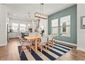 Cozy dining area with stylish chairs, a modern light fixture, and views into the kitchen at 2505 Boone Ct, Sarasota, FL 34237