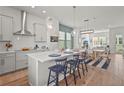 Open-concept kitchen with stainless steel appliances, a spacious island, and adjacent dining area at 2505 Boone Ct, Sarasota, FL 34237